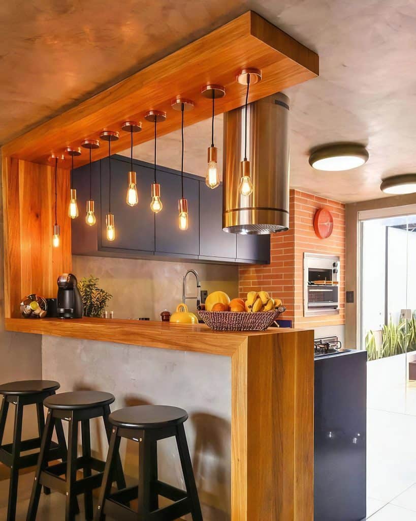 Warm wood kitchen bar with pendant lights and stools
