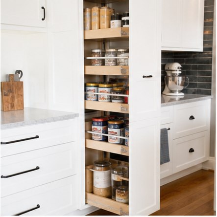 Tall white pull-out pantry cabinet beside an appliance garage