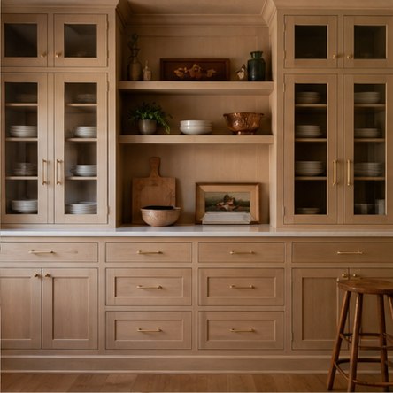 Warm wood farmhouse pantry wall with glass doors drawers and open niche