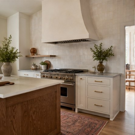 White farmhouse kitchen with plaster hood wood shelf and handmade tile