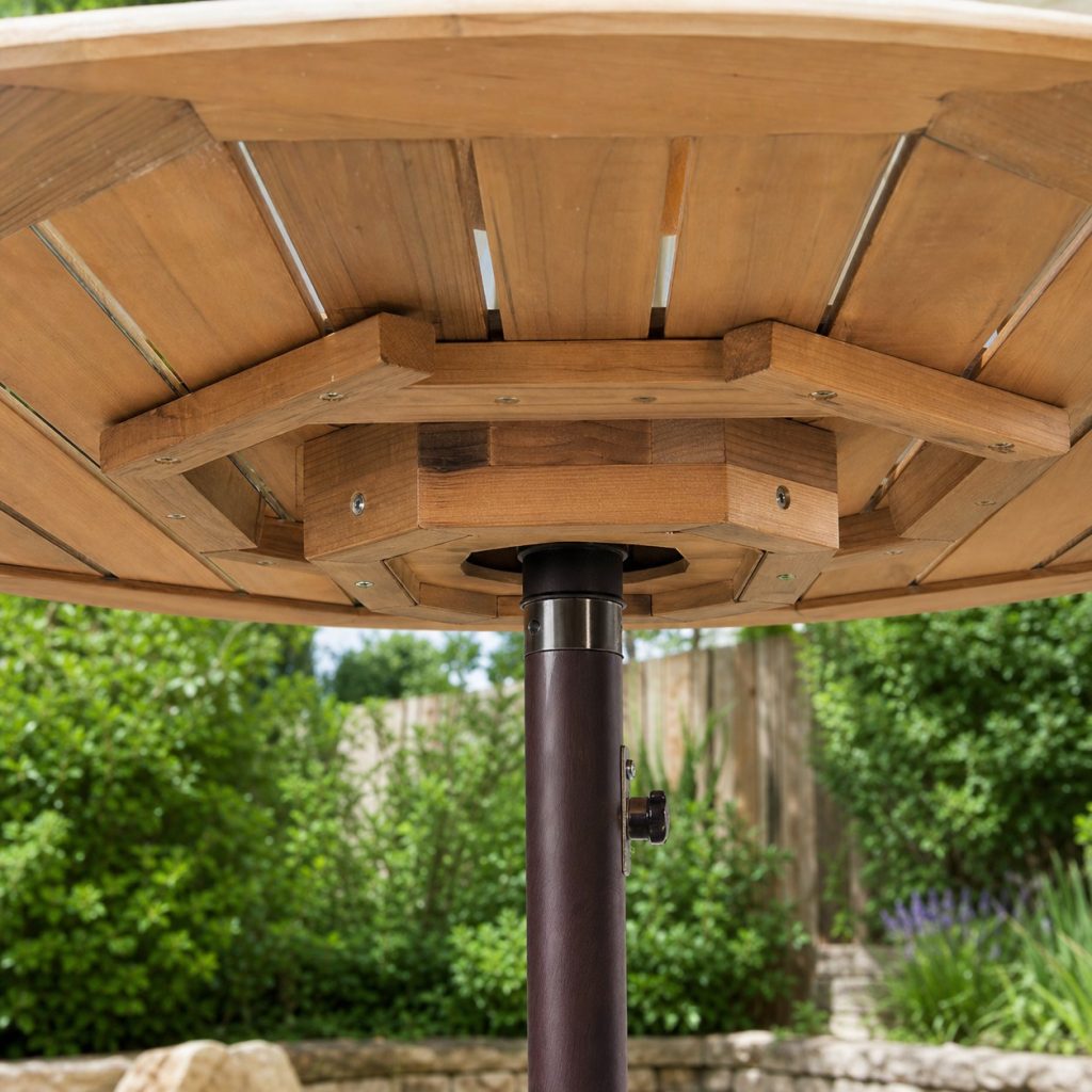 Close view beneath wooden umbrella tabletop showing reinforced opening, apron blocks, slat gaps, and sealed edges