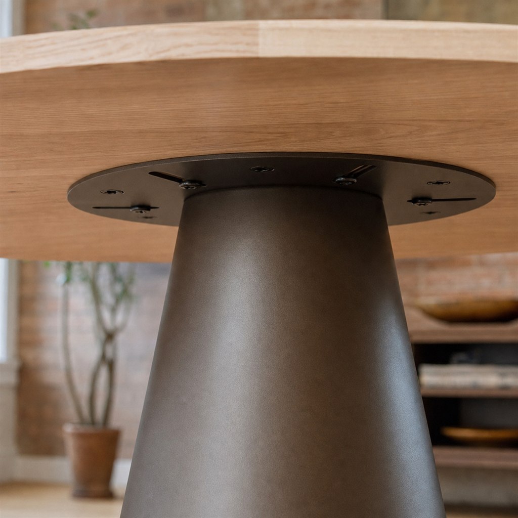 Round Ash Dining Table With a Conical Steel Pedestal - wood-to-steel interface detail