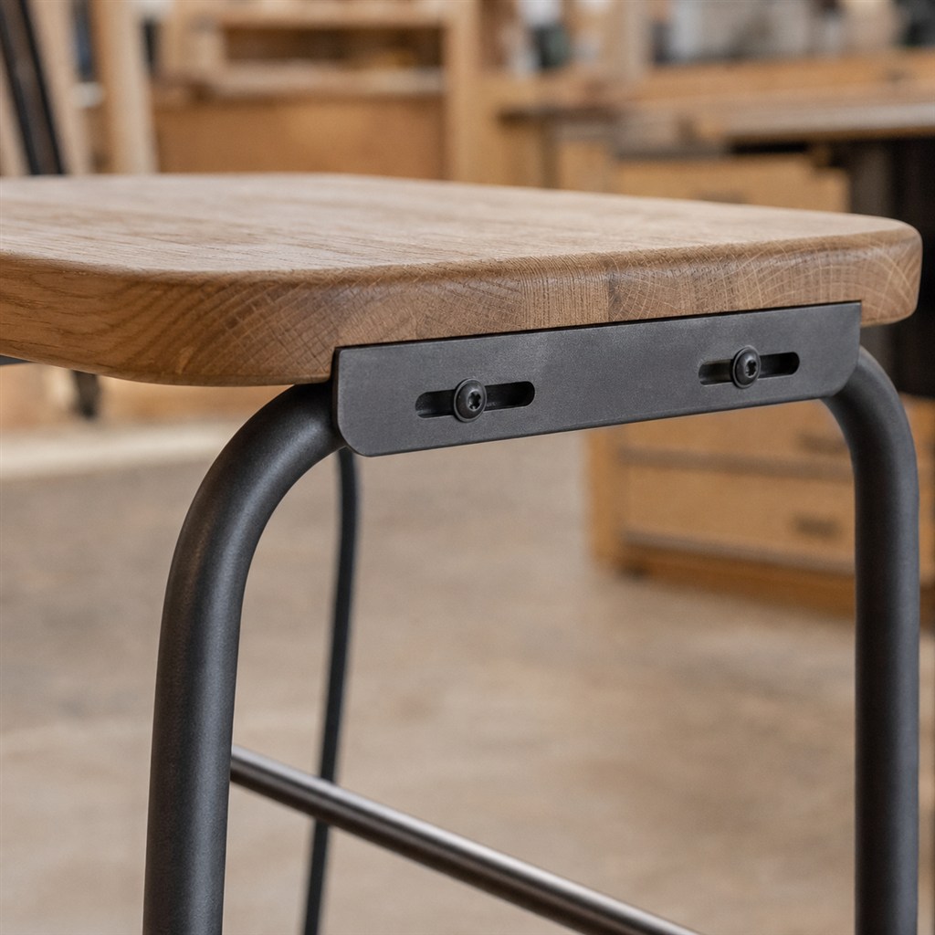 Backless Counter Stool With an Oak Seat and Steel Loop Base - wood-to-steel interface detail