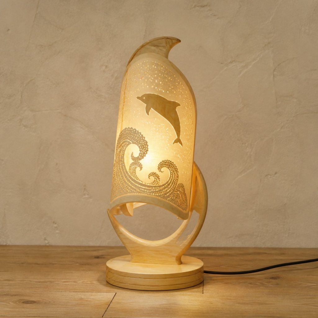 Ocean Dolphin Lantern shown as an original square photorealistic light-yellow wood dolphin lamp made from natural light-yellow wood with fine grain and warm diffused light