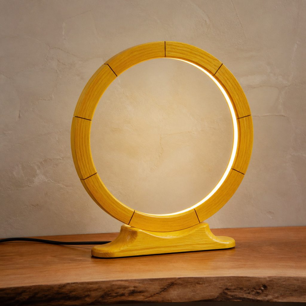 Yellowheart Segmented-Halo Lamp shown as an original square photorealistic yellowheart wood lamp with natural lemon yellow to golden yellow grain, distinctive construction, and warm diffused light